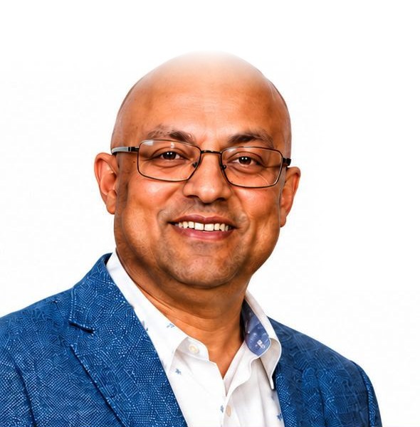 Harshal Dalal, smiling, in a blue blazer